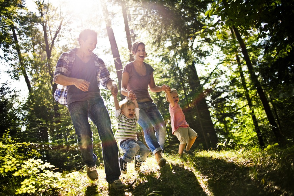 Family with two children walking in forest, having fun, Bavaria, Germany